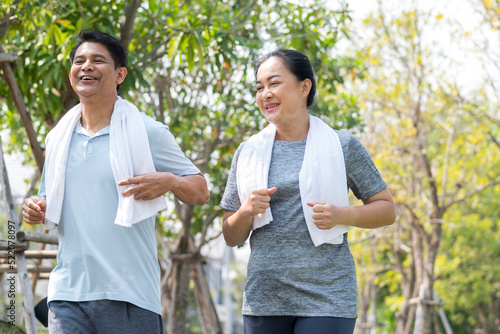 happy couple asian elder jogging running  with smile in park