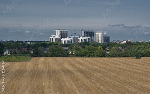 Blick über ein abgeerntetes Feld in Großziethen auf den Berliner Fernsehturm photo