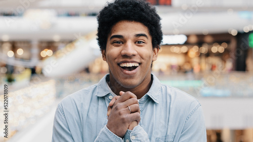 Front view portrait emotions enthusiastic surprised shocked amazed man african american guy teen looking at camera opens mouth and eyes in surprise delight winning victory luck success discount offer photo