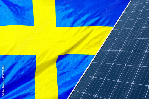 Solar panels against flag Sweden background. Solar battery generates a pure electricity. Concept of sustainable resources and renewable energy in Sweden