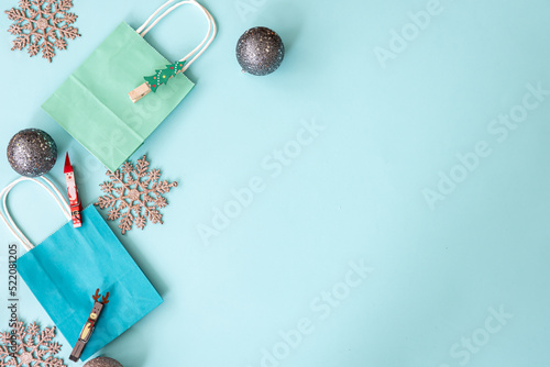 Flat lay, blue Christmas background with decor details, copy space.