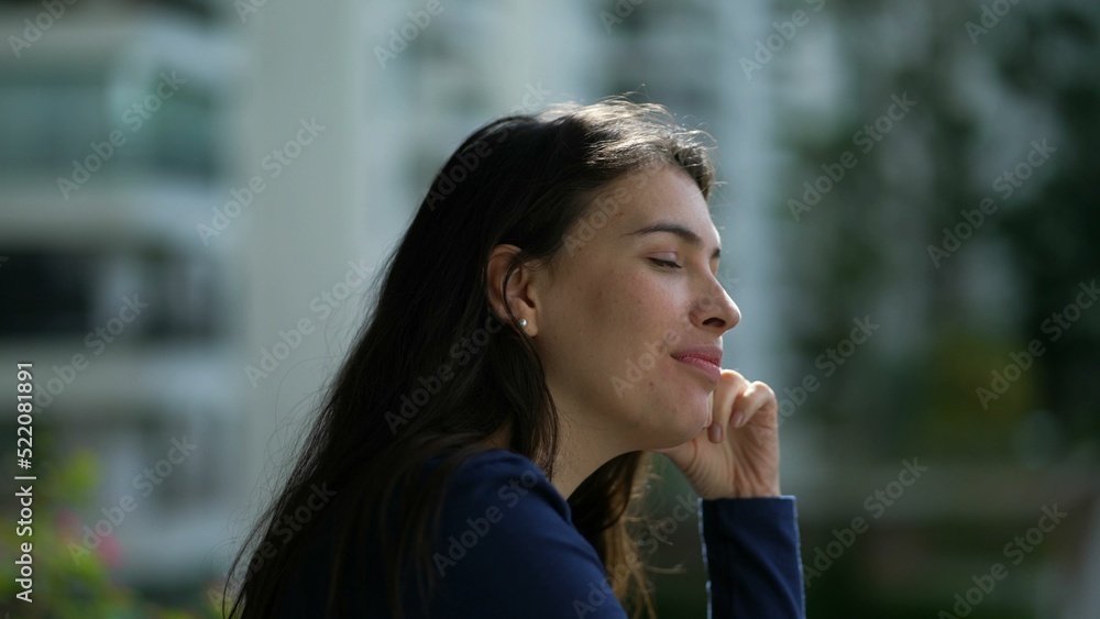 Pensive happy woman daydreaming. Thoughtful person standing at home balcony smiling