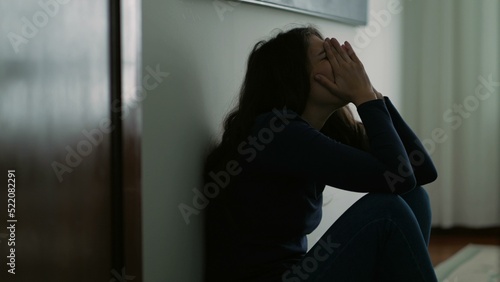 Obraz na plátně Woman feeling emotional pain sitting on floor home being desperate covering face