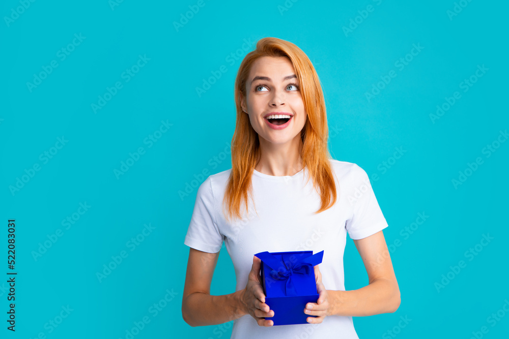 Woman with gift. Portrait of excited young girl holding gift box, isolated blue background. Pretty girl with present. Woman with gift. Portrait of excited young girl holding gift box, isolated blue background. Pretty girl with present.