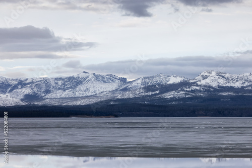 View of a frozen Yellowstone Lake with snow covered mountains in American Landscape. Yellowstone National Park. United States. Nature Background. © edb3_16