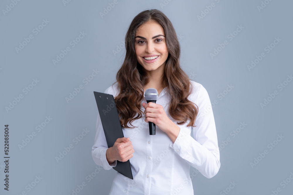 Young business woman talking with mic. Woman talking with microphone. Communication and information concept. Young business woman talking with mic. Woman talking with microphone. Communication and information concept.