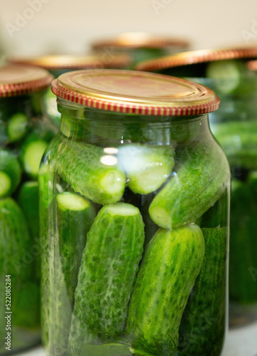 Organic cucumbers placed in jars and covered with lids, they are ready for canning