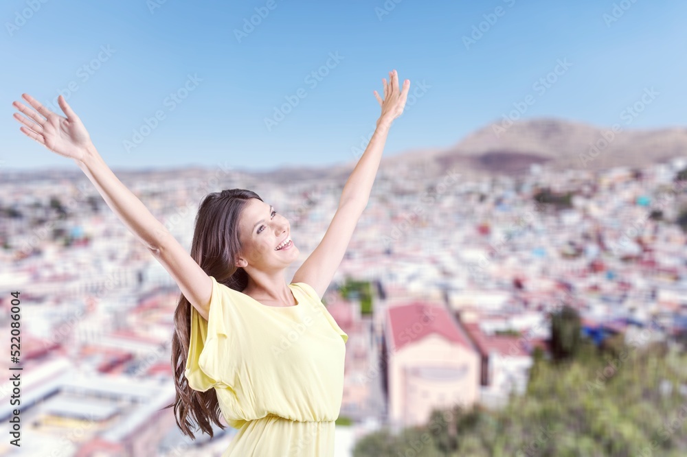 Young tourist woman on background of city. Concept freedom Young tourist woman on background of city. Concept freedom