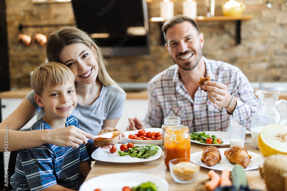Happy family  talking during lunch time at dining table