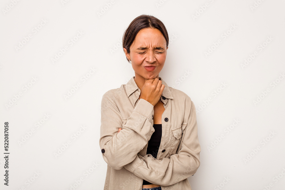 Young hispanic woman isolated on white background suffers pain in throat due a virus or infection. Young hispanic woman isolated on white background suffers pain in throat due a virus or infection.