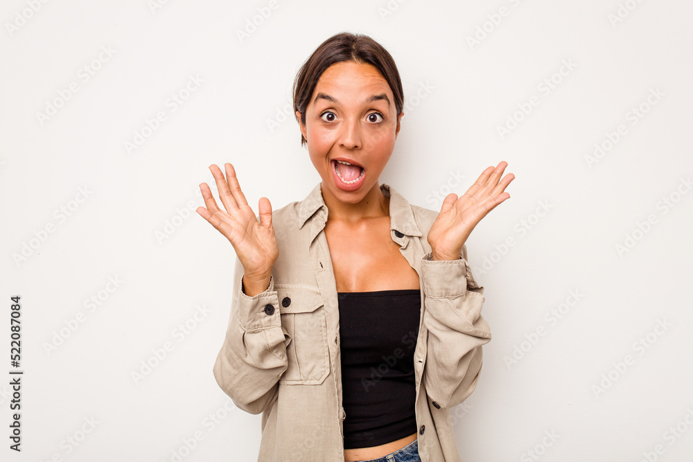 Young hispanic woman isolated on white background celebrating a victory or success, he is surprised and shocked. Young hispanic woman isolated on white background celebrating a victory or success, he is surprised and shocked.