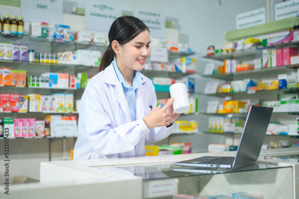 Female pharmacist counseling customer via video call in a modern pharmacy drugstore. Female pharmacist counseling customer via video call in a modern pharmacy drugstore.