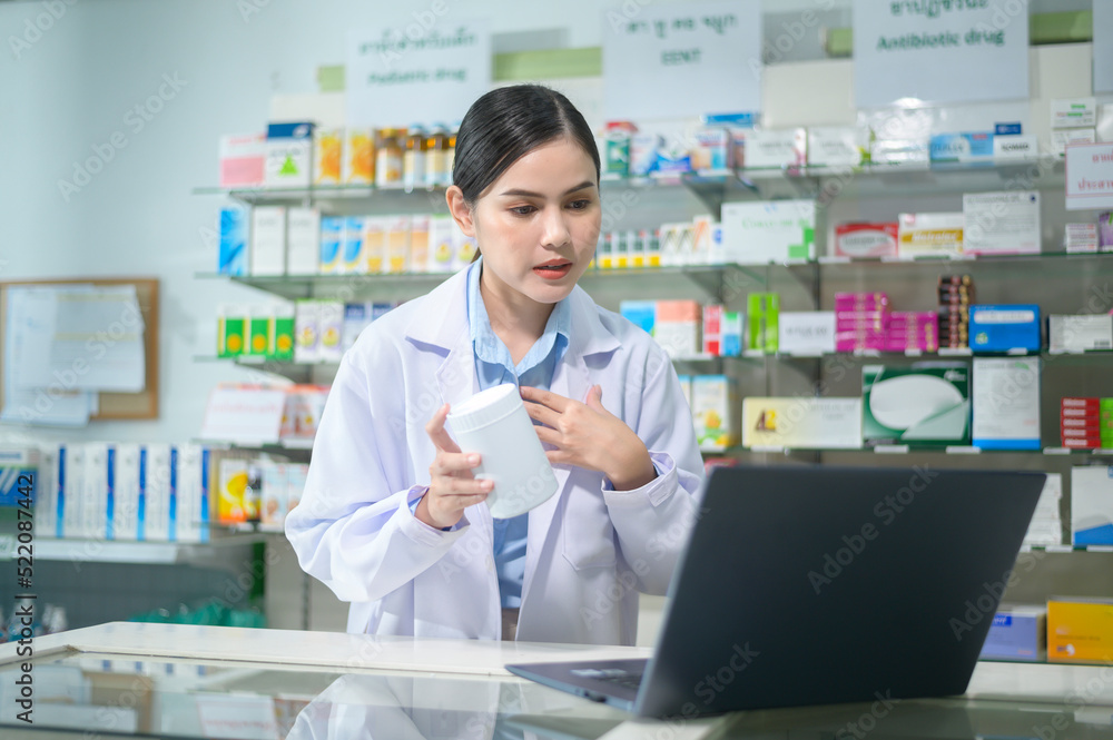 Female pharmacist counseling customer via video call in a modern pharmacy drugstore. Female pharmacist counseling customer via video call in a modern pharmacy drugstore.