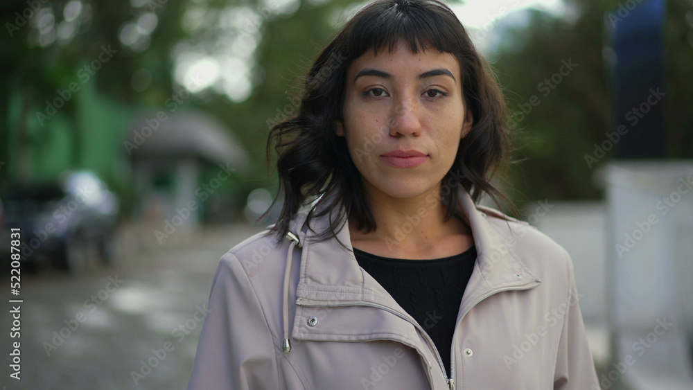 A serious latina hispanic woman walks forward toward camera A serious latina hispanic woman walks forward toward camera