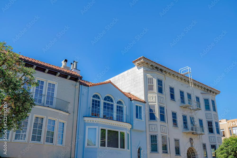 Two single family houses along with an apartment building with emergency stairs in San Francisco, CA