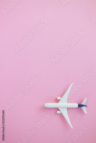 Travel concept on pink background with copy space. Airplane toy on pink color background.