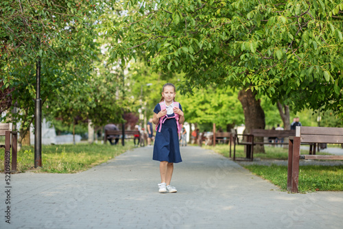 Beautiful child girl with backpack goes to school. Concept of back to school, education