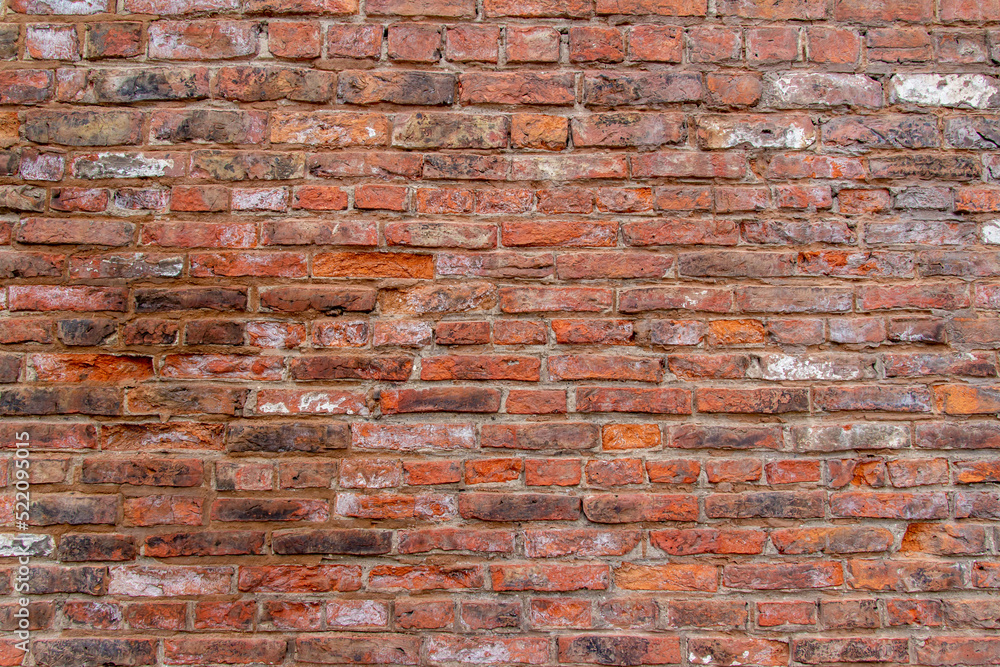 Fototapeta premium Full frame texture background of an antique European brown and red color brick wall in an Old English Bond brickwork pattern