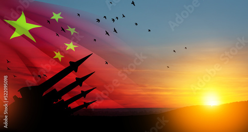 The missiles are aimed at the sky at sunset with China flag. Nuclear bomb, chemical weapons, missile defense, a system of salvo fire. 3d-rendering. photo