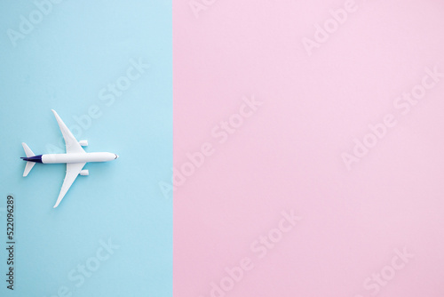 Miniature toy airplane on color background. Trip by airplane.