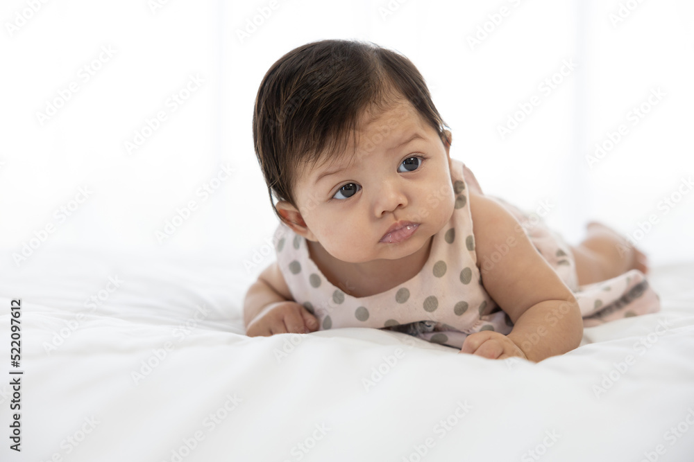 portrait cute baby crawling on bed and looking to something portrait cute baby crawling on bed and looking to something
