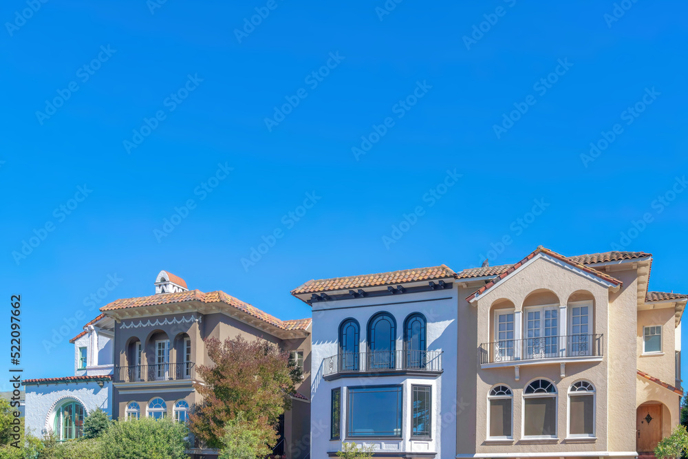 Facade of mediterranean homes with arched doors at the balconies in San Francisco, California Facade of mediterranean homes with arched doors at the balconies in San Francisco, California