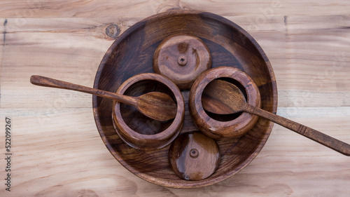 wooden utensils. wooden plate with pots and spoons. wooden sugar pots with natural background. vintage. utensils. 