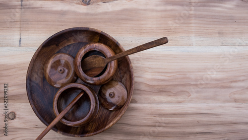 wooden utensils. wooden plate with pots and spoons. wooden sugar pots with natural background. vintage. utensils.	