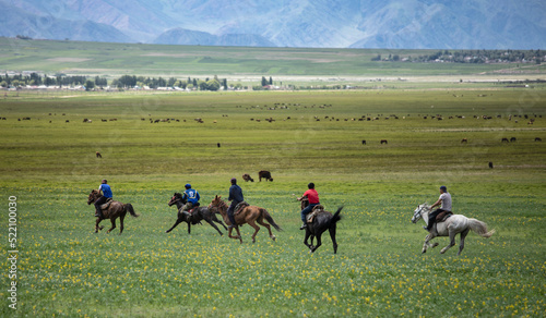 Men riding horseback during a game of Kok Boru in rural Kyrgyzstan.