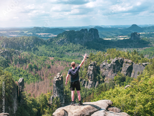 Hiker shouts greetings to valley and Schrammsteine rocks