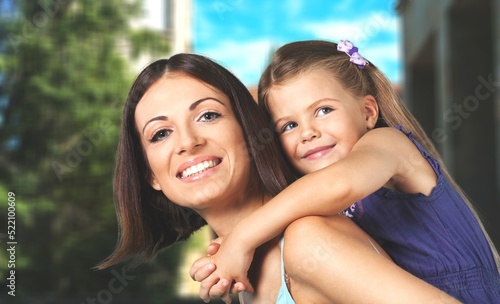 Happy mother having fun with her daughter outdoor