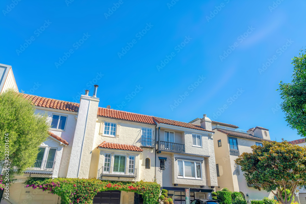 Fototapeta premium Mediterranean townhouses with attached garage and flues in San Francisco, CA