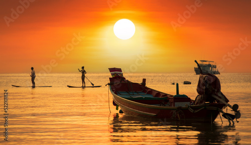 Sunset on Koh Tao Island. Traditional boats and tropical island landscape. Thailand's famous travel and holiday island. 