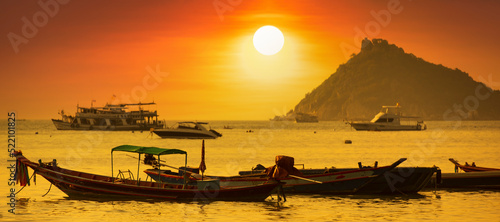 Sunset on Koh Tao Island. Traditional boats and tropical island landscape. Thailand s famous travel and holiday island. 