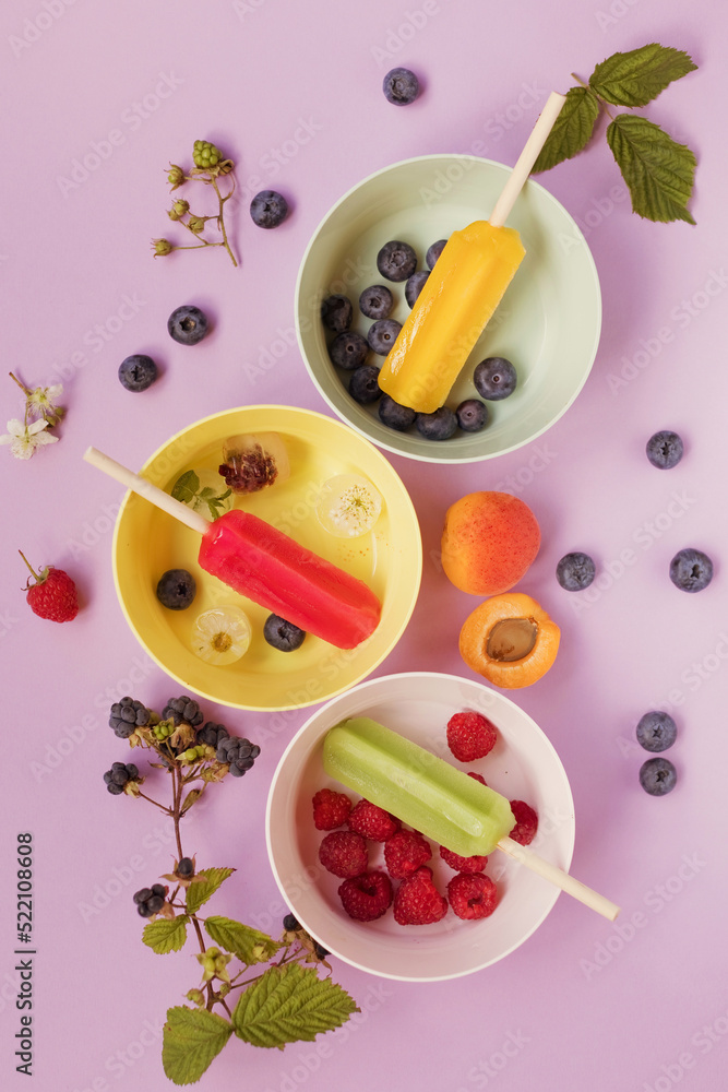 Colorful popsicles in bowls close up Colorful popsicles in bowls close up