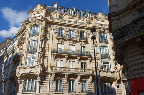 The facades of traditional French houses with typical balconies and windows. Paris. © kovalenkovpetr