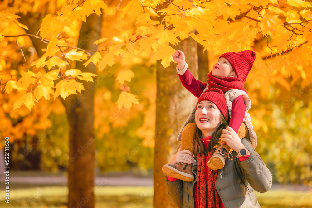 Happy mother and daughter having fun in autumn park. Happy mother and child daughter on autumn walk. Happy mother and daughter having fun in autumn park. Happy mother and child daughter on autumn walk.