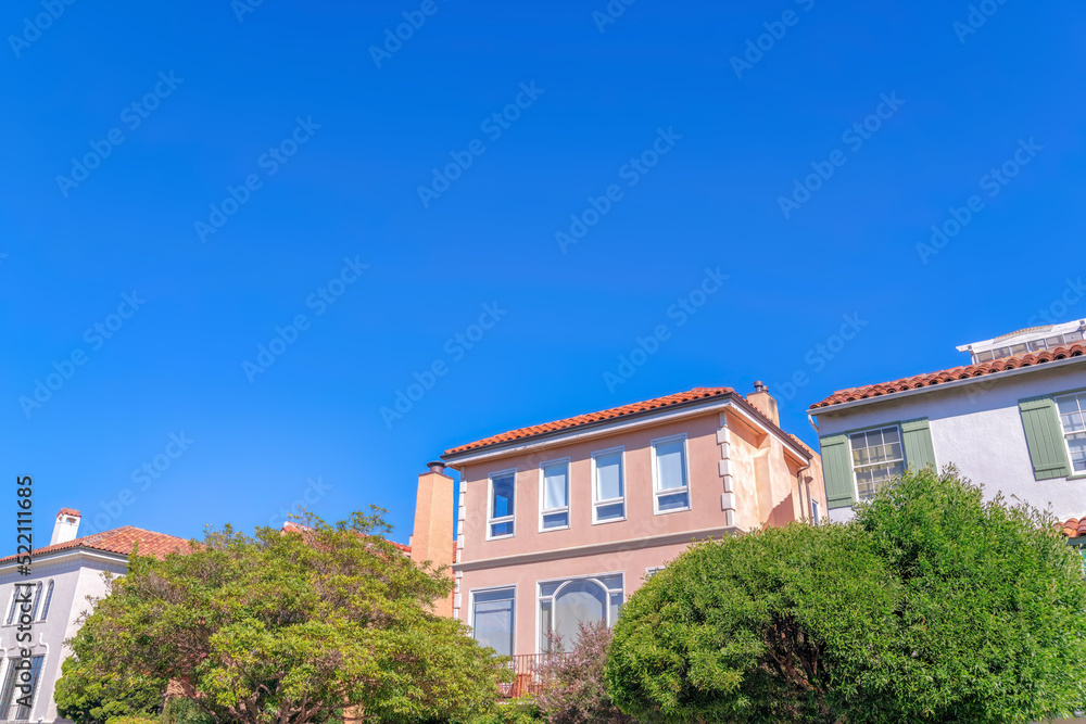 Trees at the front of residential buildings with modern mediterranean exterior at San Francisco, CA