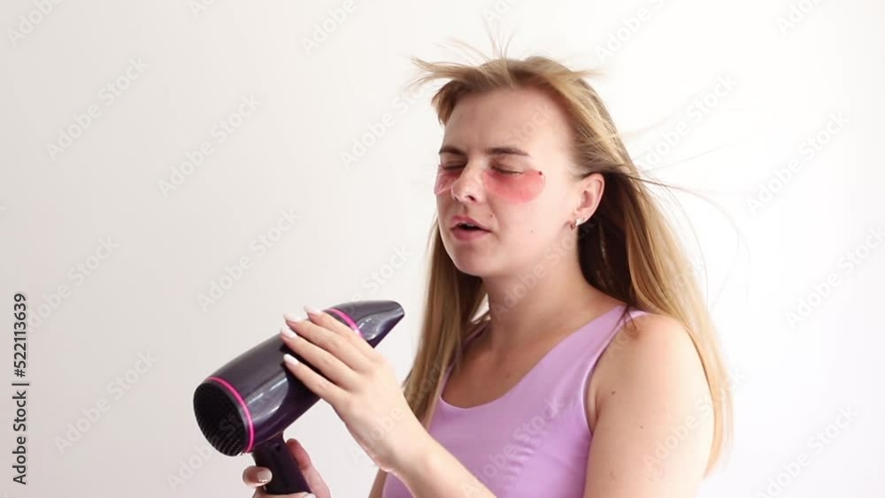 happy woman singing with hair dryer happy woman singing with hair dryer