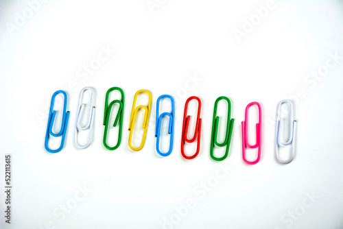 Colored paper clips on a white background.