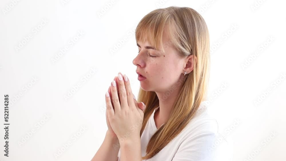 a woman prays and asks for help on a gray background a woman prays and asks for help on a gray background
