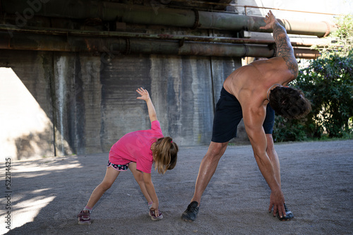 A father and his daughter doing fitness exercises. photo