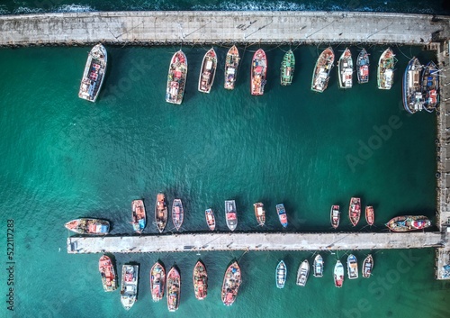 Aerial drone shot of many fishing boats in Kalk Bay harbour, near Cape Town, South Africa photo