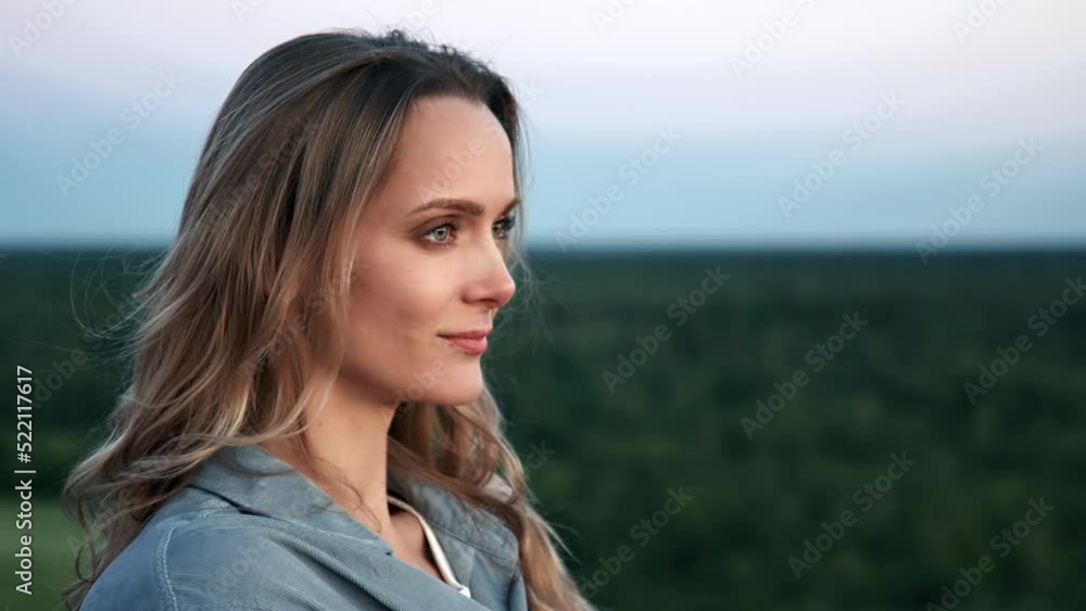 Closeup smiling female face admiring nature landscape evening morning horizon dreaming freedom Closeup smiling female face admiring nature landscape evening morning horizon dreaming freedom