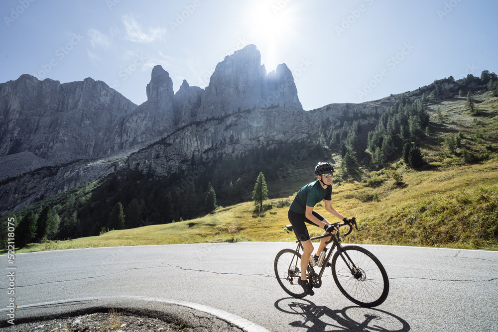 Road cyclist climbing the Italian Dolomites