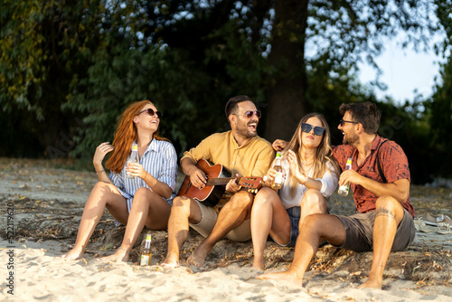 group of friends having fun on the beach