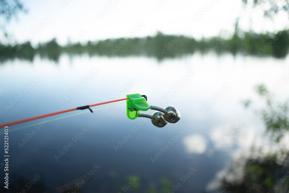 bell alarm is on fishing rod spinning in nature bells of allure are  attached to the