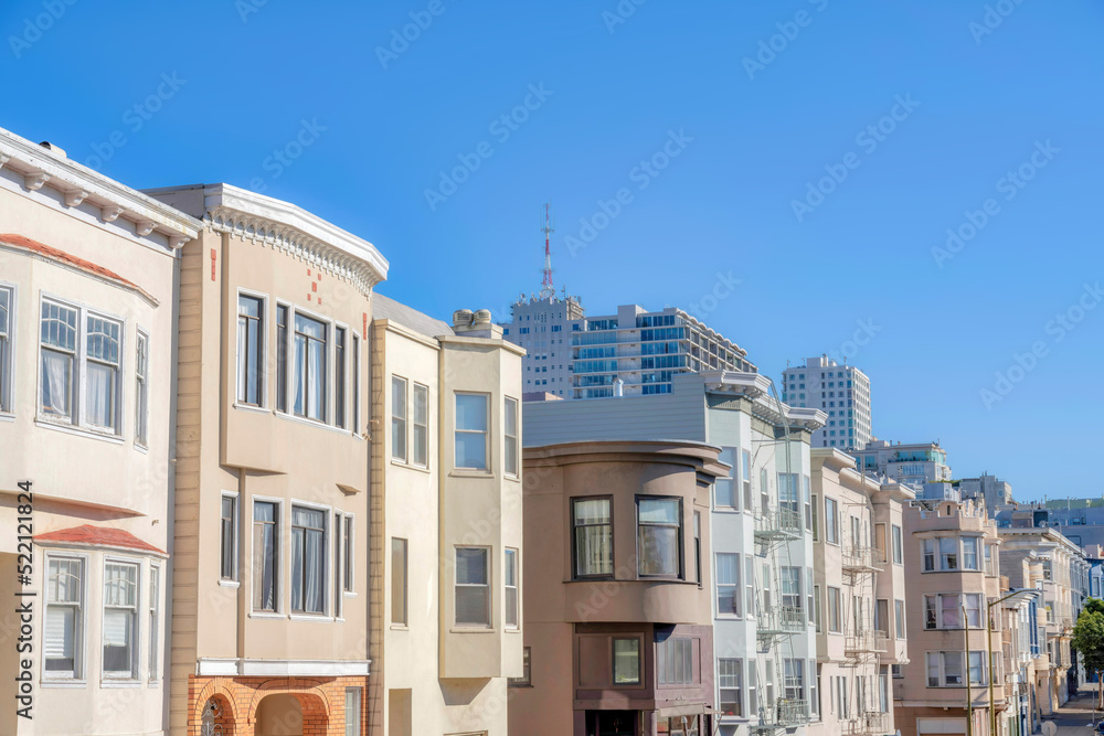 Row of apartments in San Francisco, CA near the commercial buildings at the back
