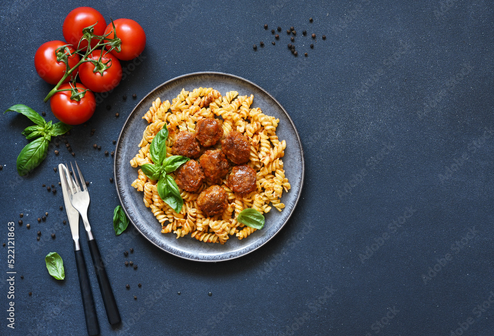 Italian pasta with meatballs, tomato sauce and spices, top view, with space for text Italian pasta with meatballs, tomato sauce and spices, top view, with space for text
