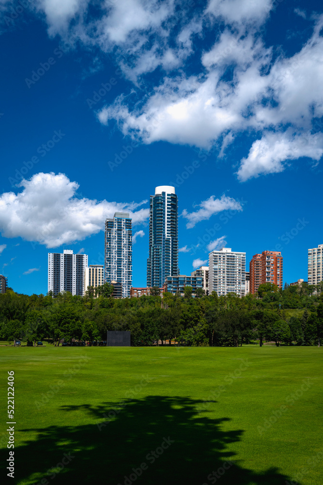 Edmonton cityscape with dramatic clouds over Victoria Park's green in the Province of Alberta, Canada